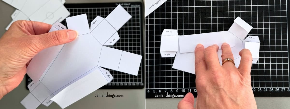 To billeder viser, hvordan en hvid papirkiste foldes og formes. De yderste vægge bøjes indad, så kisten får dobbelte sidevægge.
© Christel Parby · danishthings.com · #DanishThings #Kistebund #Papirfoldning #HalloweenDIY